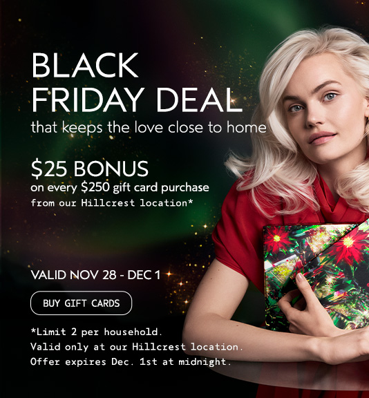 A woman with platinum blonde hair holds wrapped gifts. Text reads: 'Woman in red dress holding gift, promoting a Black Friday deal: $25 bonus for every $250 gift card purchase at Hillcrest location, valid Nov 28 - Dec 1. Terms and conditions apply. - Gila Rut Salon | San Diego and Chula Visa, CA
